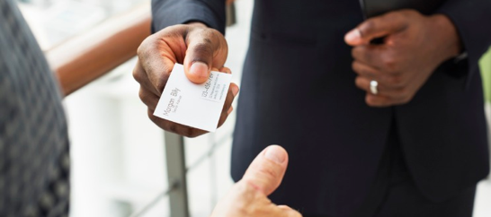 a man passing business card